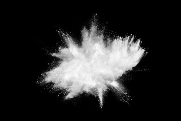 Explosion of white powder isolated on black background.