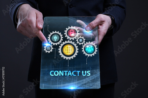 Business, Technology, Internet and network concept. Young businessman working on a virtual screen of the future and sees the inscription: Contact us