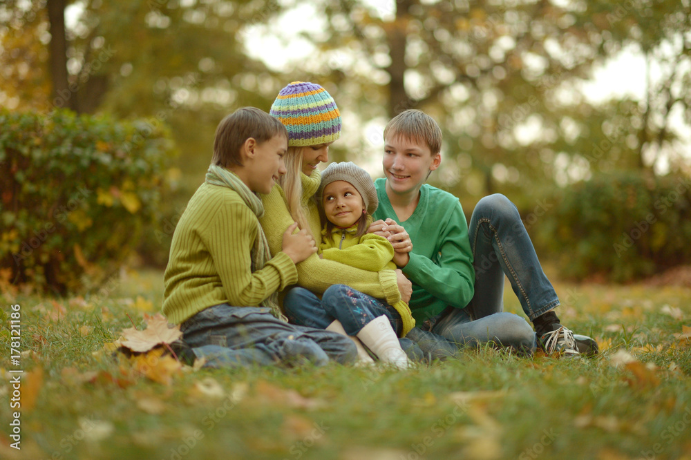 mother and children relaxing in park