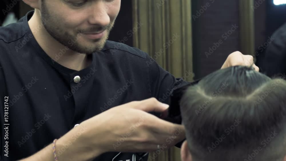 Barbershop. A creative hairdresser does a stylish haircut. A hairdresser creates a fashionable image for the young guy. Barbershop. A creative hairdresser does a stylish haircut. A hairdresser creates a fashionable image for the young guy.