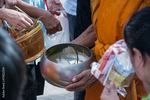  Buddhist monks are given food offering from people for End of Buddhist Lent Day