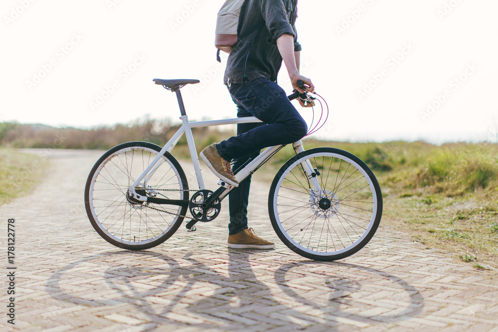 Man waiting with his bike on path in the dunes