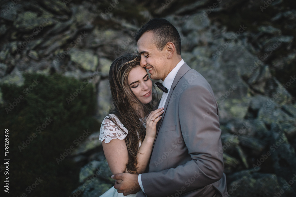 Romantic couple standing together holding hands in the mountains