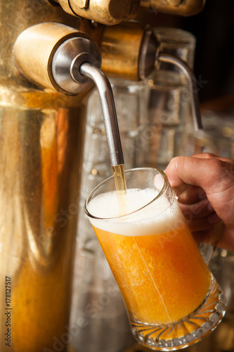 A fresh draft beer or lager being prepared in a bar or brewery