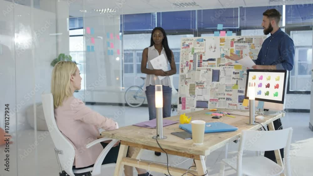 Designers giving presentation to manager or client in creative office. Designers giving presentation to manager or client in creative office.