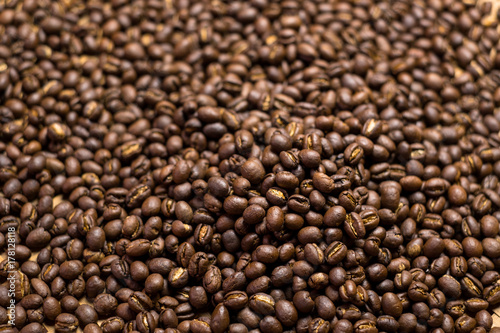Depth of field shot, soft focus, Medium dark Roasted peaberry coffee beans background.