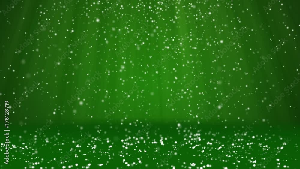 Snow fall and settle on the surface. Green winter background as place for advertisement or logo, Christmas or New Year cards. Seamless looped background with DOF, copy space, light rays 1 Snow fall and settle on the surface. Green winter background as place for advertisement or logo, Christmas or New Year cards. Seamless looped background with DOF, copy space, light rays 1