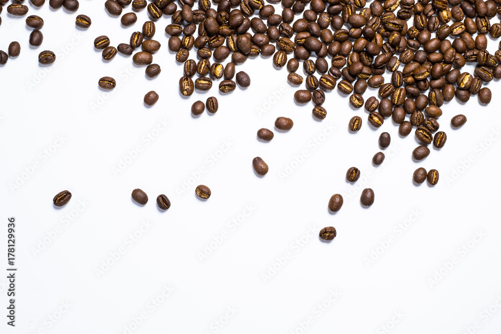 Flay lay style, Medium dark Roasted peaberry coffee beans isolated on white background with copy space for text. Flay lay style, Medium dark Roasted peaberry coffee beans isolated on white background with copy space for text.