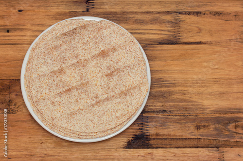 pita on white plate on wooden background