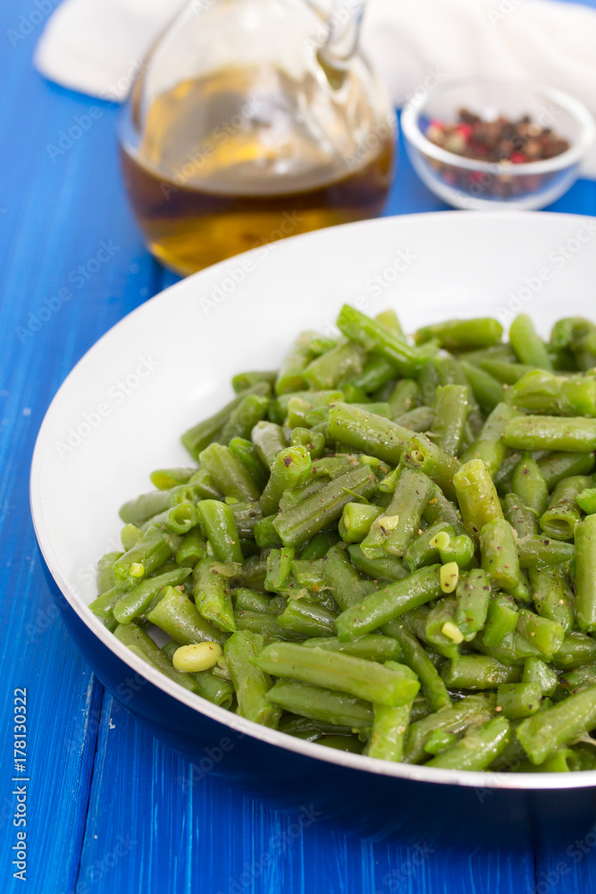 green beans on frying pan on wooden background green beans on frying pan on wooden background