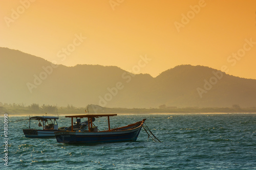 Boat by the sea at sunset