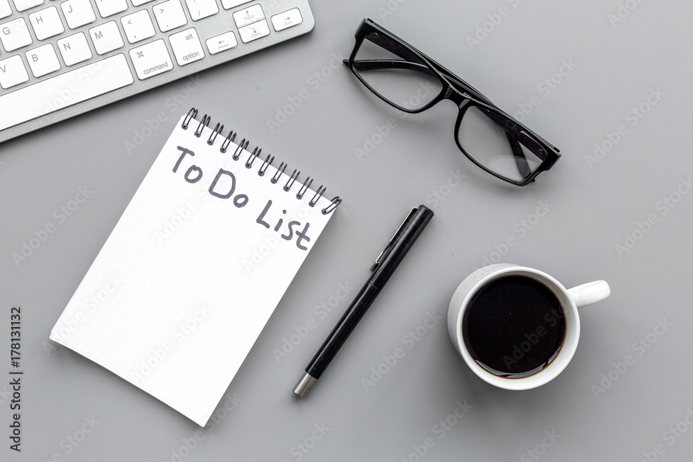 To do list for businessman in notebook on office table. Grey background top view mockup