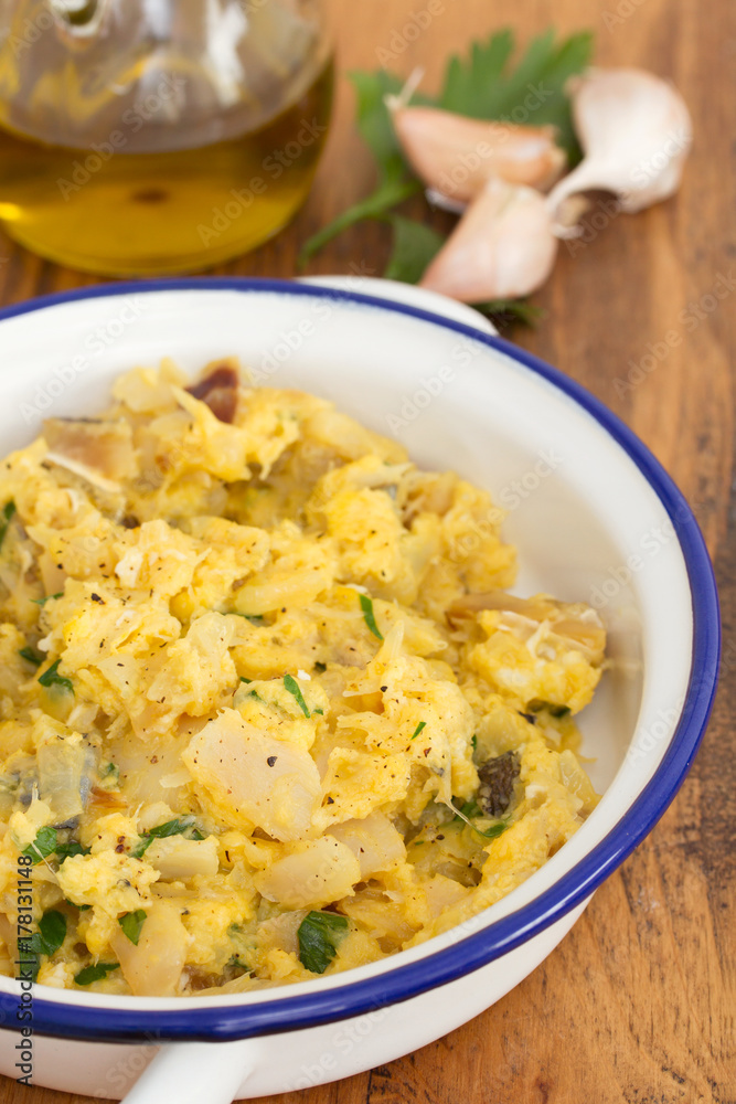 codfish with egg and herbs on white dish