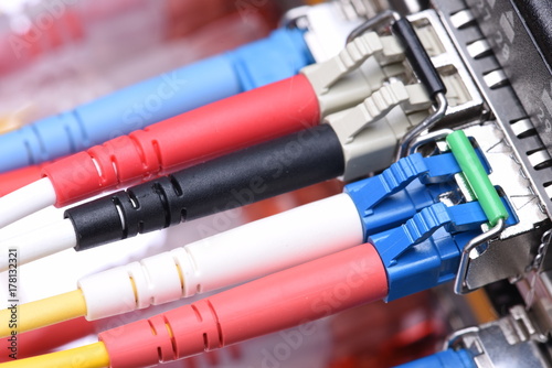 Close up of switch port with fiber optical network cables patch cords