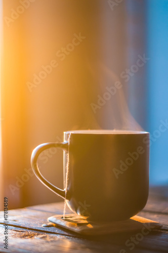 Still life with cup of coffee on the carpathian mountains background during the sunset