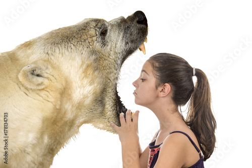 Φωτογραφία Young fearless girl with a polar bear on a white background