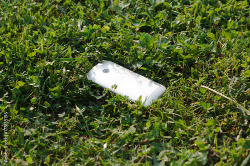 Lost smartphone lying in the grass