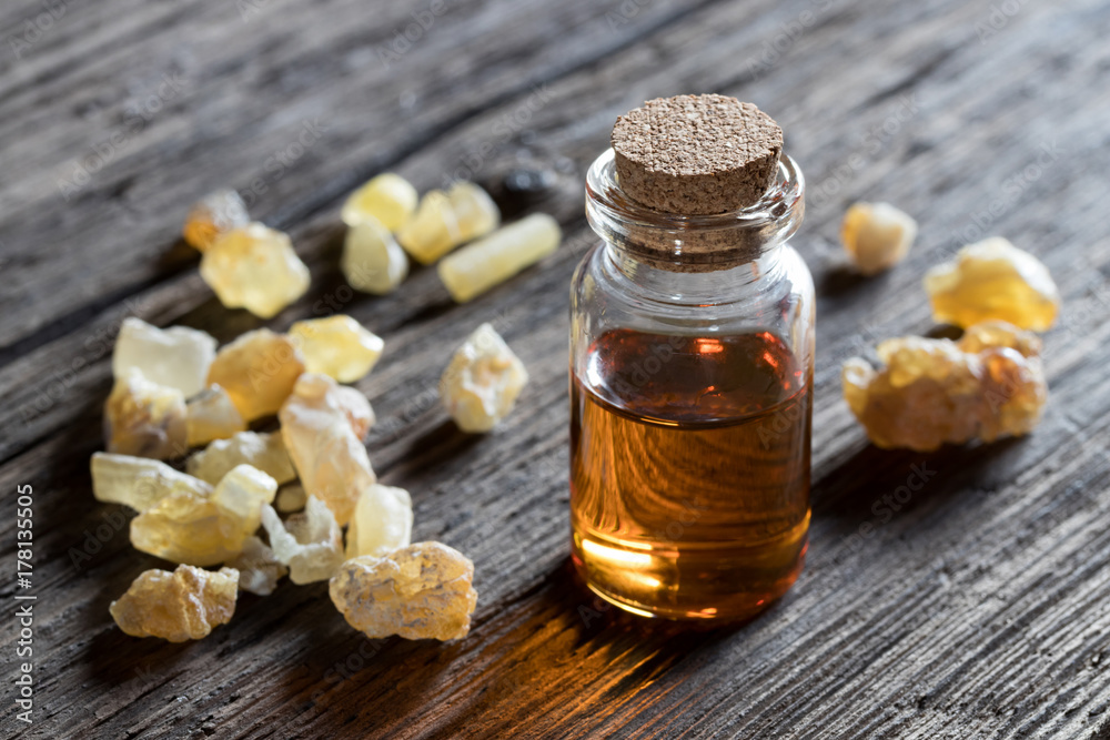 A bottle of frankincense essential oil with frankincense resin A bottle of frankincense essential oil with frankincense resin