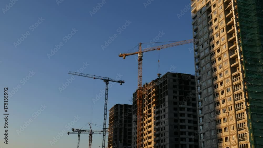 Crane lifting construction material
