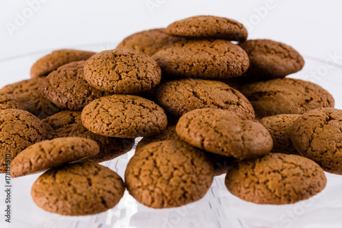 pile of homemade speculaas (type of spiced biscuit made of brown sugar & cinnamon) for the St Nicholas day (Sinterklaas) on white background