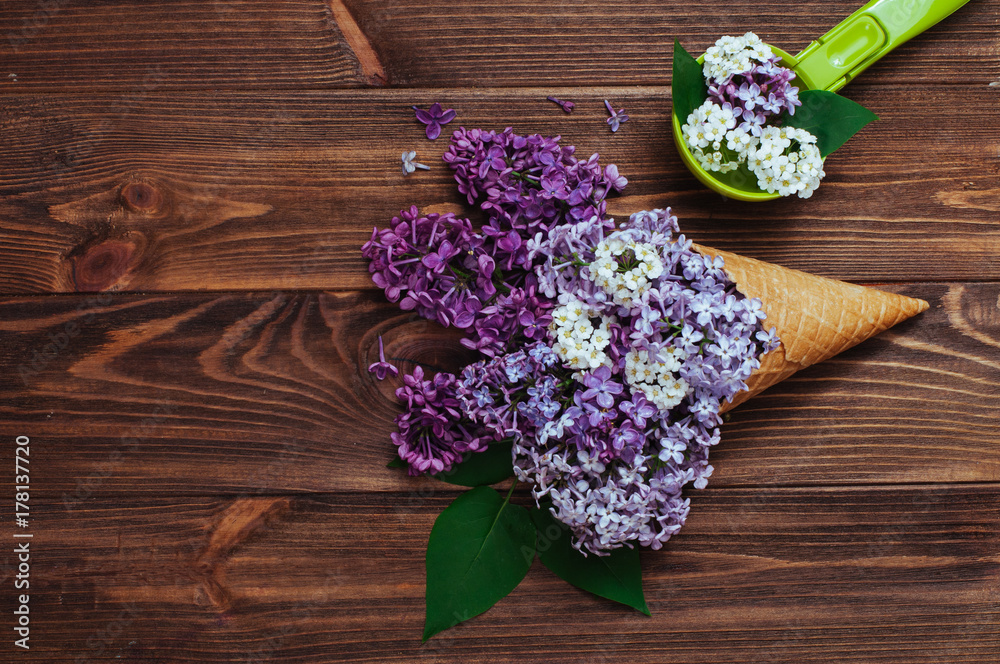 Ice cream waffle cone with lilac flowers and spoon Ice cream waffle cone with lilac flowers and spoon
