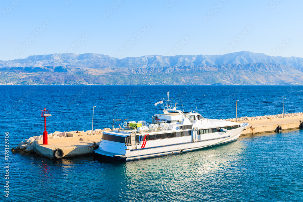Tourist ferry ship anchoring in Supetar port on Brac island, Croatia