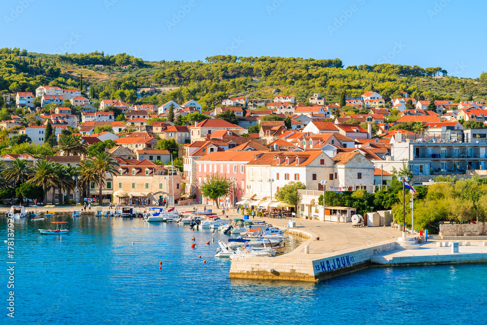 SUPETAR PORT, CROATIA - SEP 15, 2017: View of Supetar port with colorful houses and boats, Brac island, Croatia.