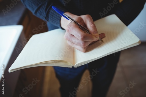 Man writing in organizer photo