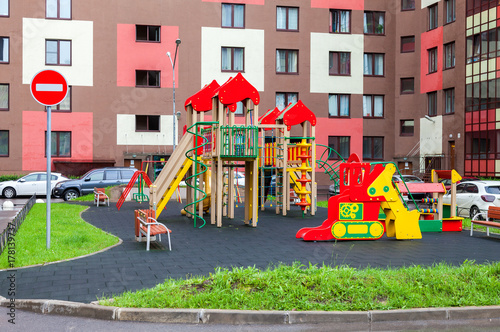 Colorful сhildren's playground for kids in new district with many slides, swings, toys for play
