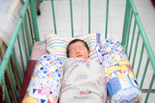 Close Up of Asian Baby Sleeping in Trellis