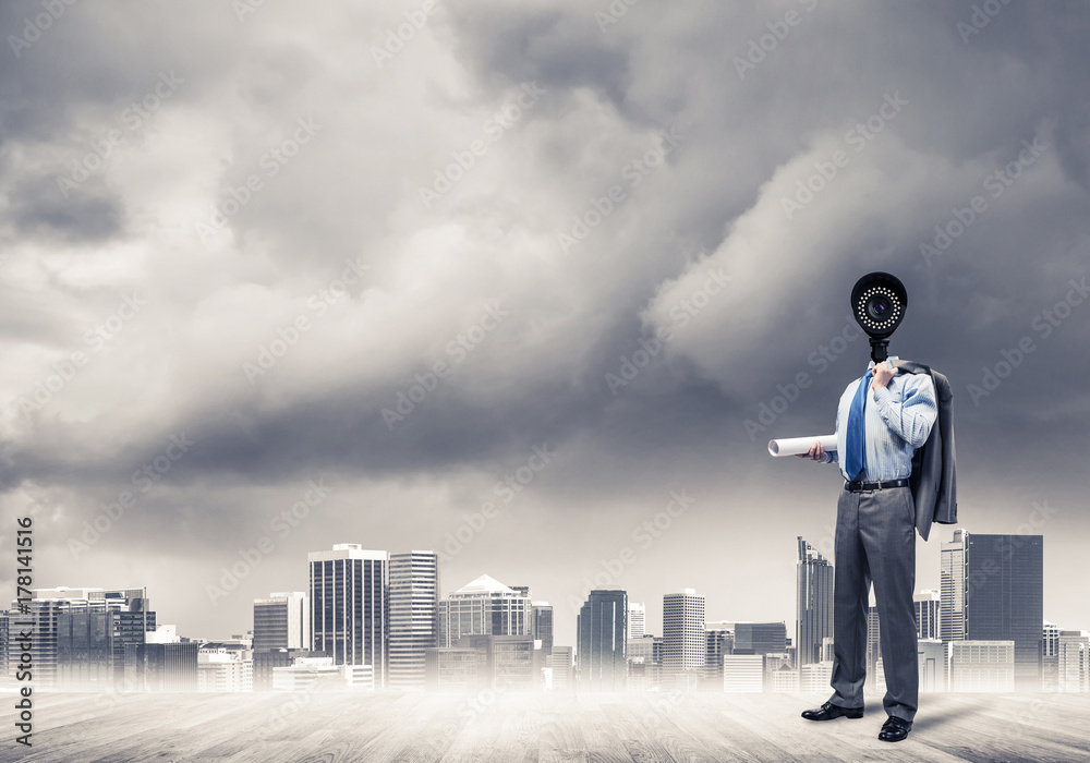 Camera headed man standing on wooden floor against modern citysc Camera headed man standing on wooden floor against modern citysc