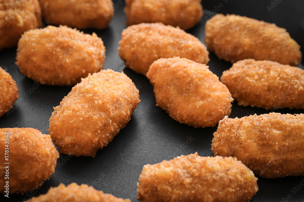 Delicious salmon croquettes on frying pan, closeup Delicious salmon croquettes on frying pan, closeup