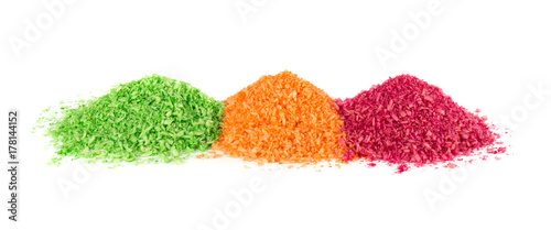 Heap of shredded coconut on white background. Dried grated coconut. Multicolored dyed shredded coconut.