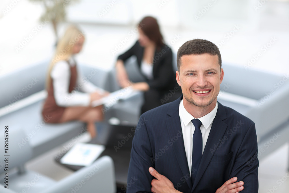 young businessman on blurred background office. young businessman on blurred background office.