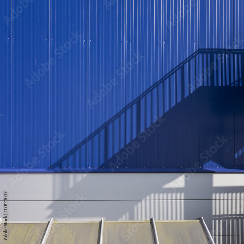 Stairs shadows on blue wall  photo