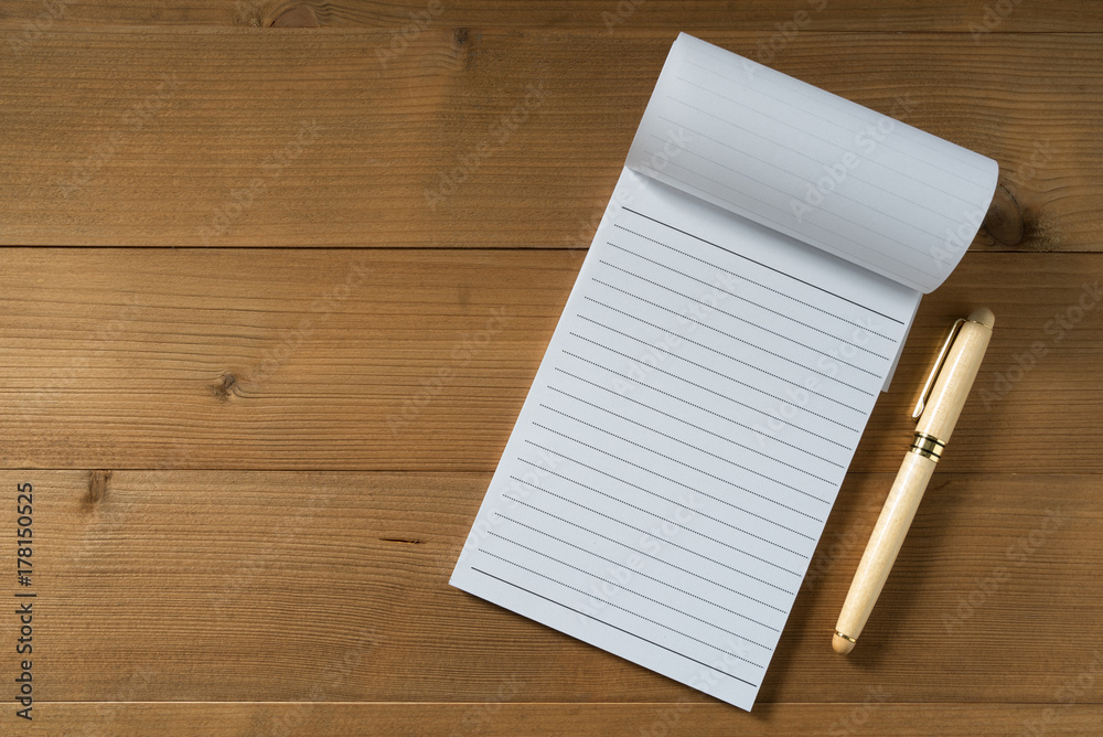 blank notebook with pen on brown wood table blank notebook with pen on brown wood table