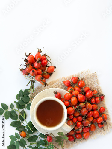 dog rose hips and herbal Te a on white background 