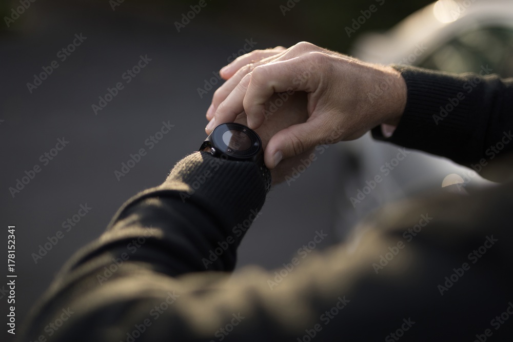 Senior man checking time on his watch Senior man checking time on his watch