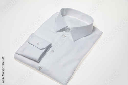 Single Folded and Ironed Male Shirt with a Collar and Buttons, Isolated on White Background