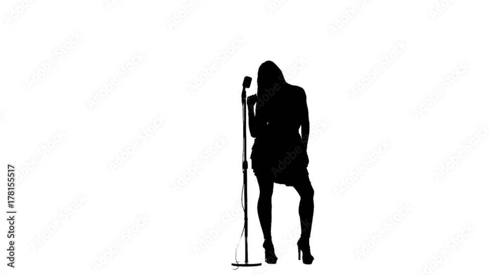 Girl sings in a retro microphone. Silhouette. White background. Slow motion Girl sings in a retro microphone. Silhouette. White background. Slow motion