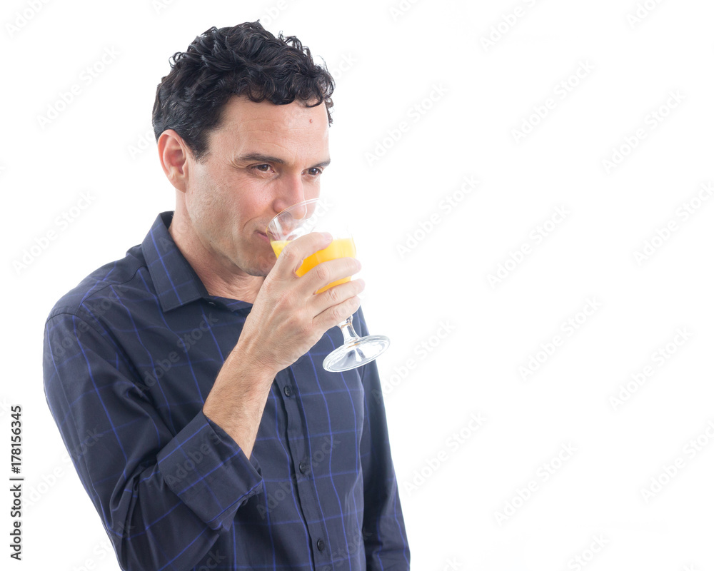 Healthy man is drinking orange juice. The person is wearing dark blue social shirt. Isolated.. Healthy man is drinking orange juice. The person is wearing dark blue social shirt. Isolated..