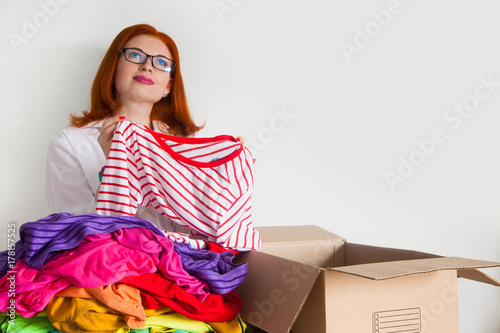 A woman is busy with the clutter in her wardrobe. photo