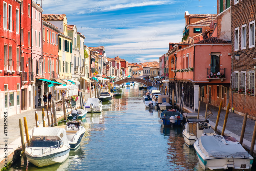 Colorful old houses and bridge over the canal at the island of Murano near Venice