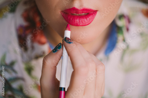 Woman Applying Lipstick photo