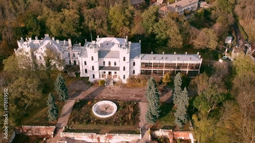 Aerial view on abandoned ruined castle and park. Autumn color footage in sunset light. photo