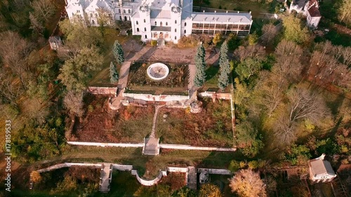 Aerial view on abandoned ruined castle and park. Autumn color footage in sunset light. photo