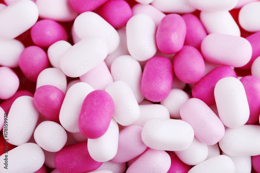 Pink and white candies gum on a red table Pink and white candies gum on a red table