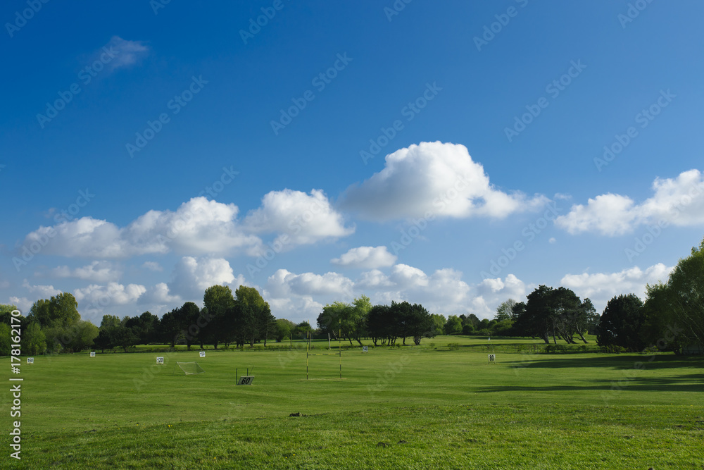 General view of a green golf course on a bright sunny day. Idyllic summer landscape. Sport, relax, recreation and leisure concept General view of a green golf course on a bright sunny day. Idyllic summer landscape. Sport, relax, recreation and leisure concept