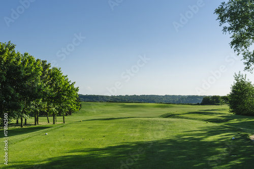 General view of a green golf course on a bright sunny day. Idyllic summer landscape. Sport  relax  recreation and leisure concept
