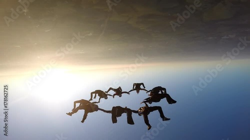 Skydivers at the sunset